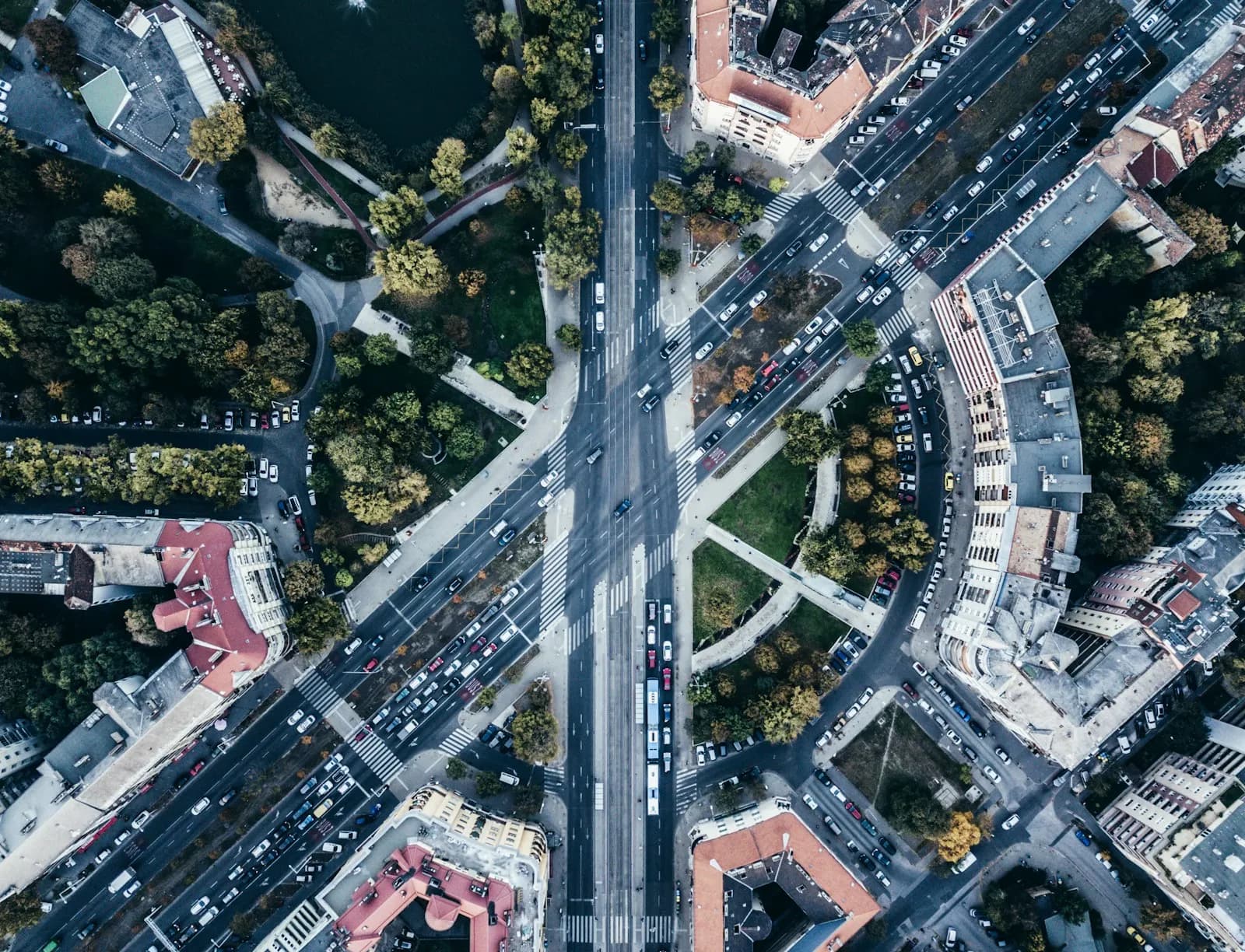 Luftaufnahme einer städtischen Straßenkreuzung mit Fahrzeugen und Straßenbahngleisen